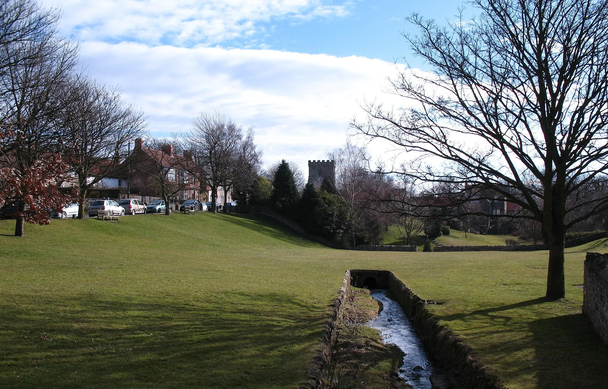 Photo showing: The Green, Melsonby Village green with tiny beck which disappears into a culvert.