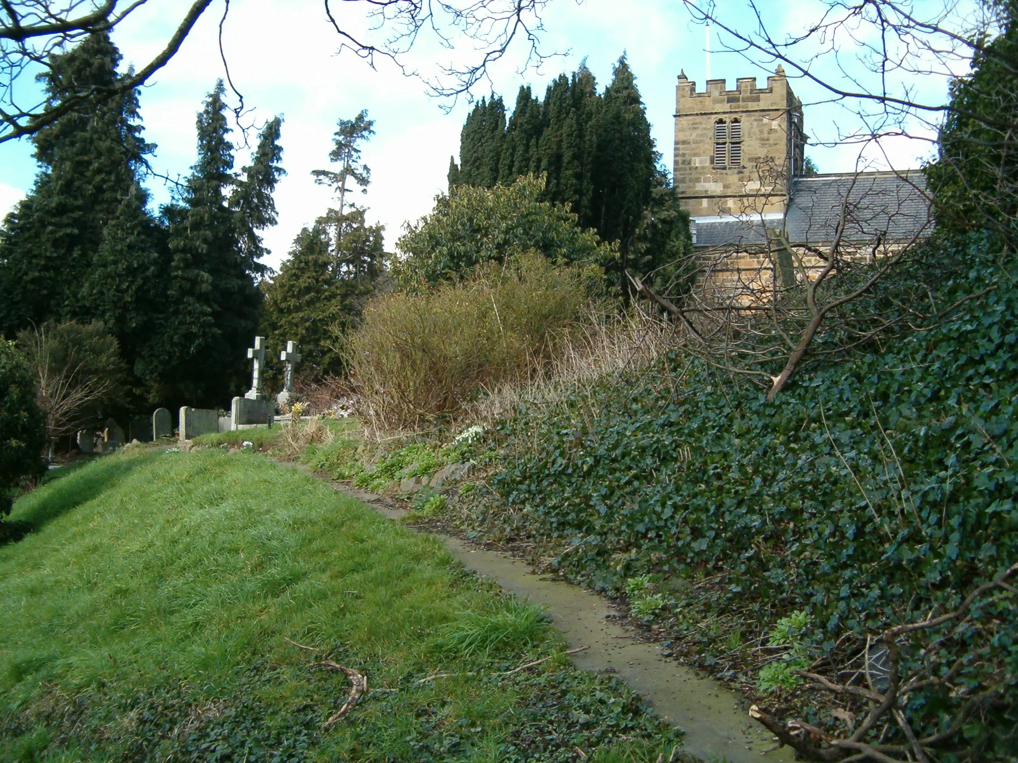 Photo showing: West tower and part of the churchyard of SS Peter and Paul parish church, Stainton, in the ward of Thornton and Stainton, in the borough of Middlesbrough in ceremonial North Yorkshire, England