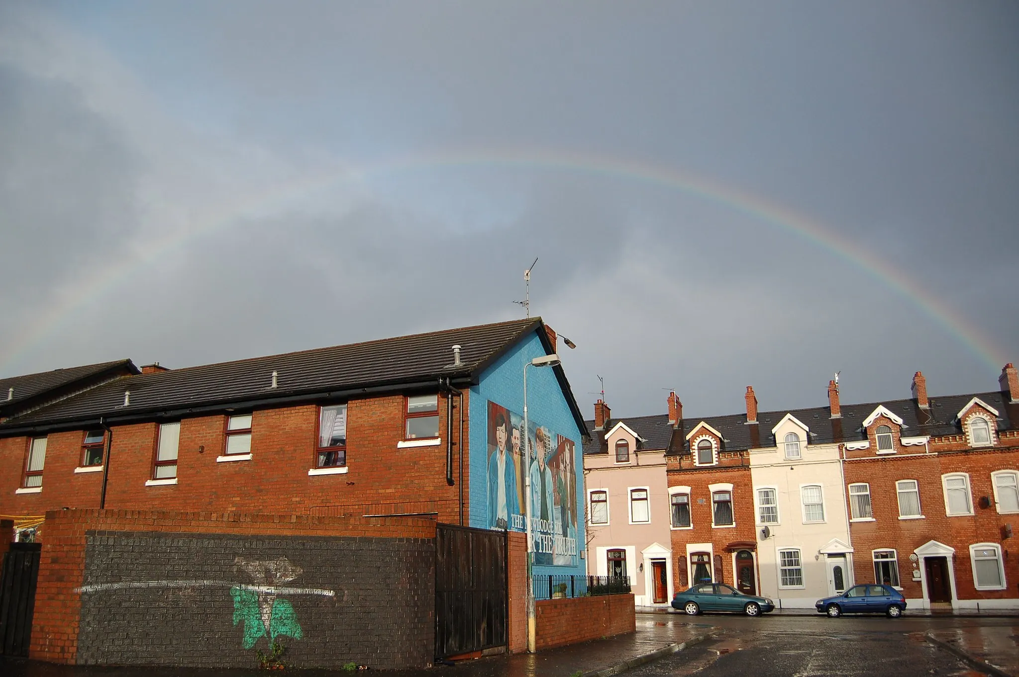 Photo showing: (C), 2005, Gerry Lynch.  Rainbow over Donore Court in the New Lodge area of North Belfast, along with Republican murals.