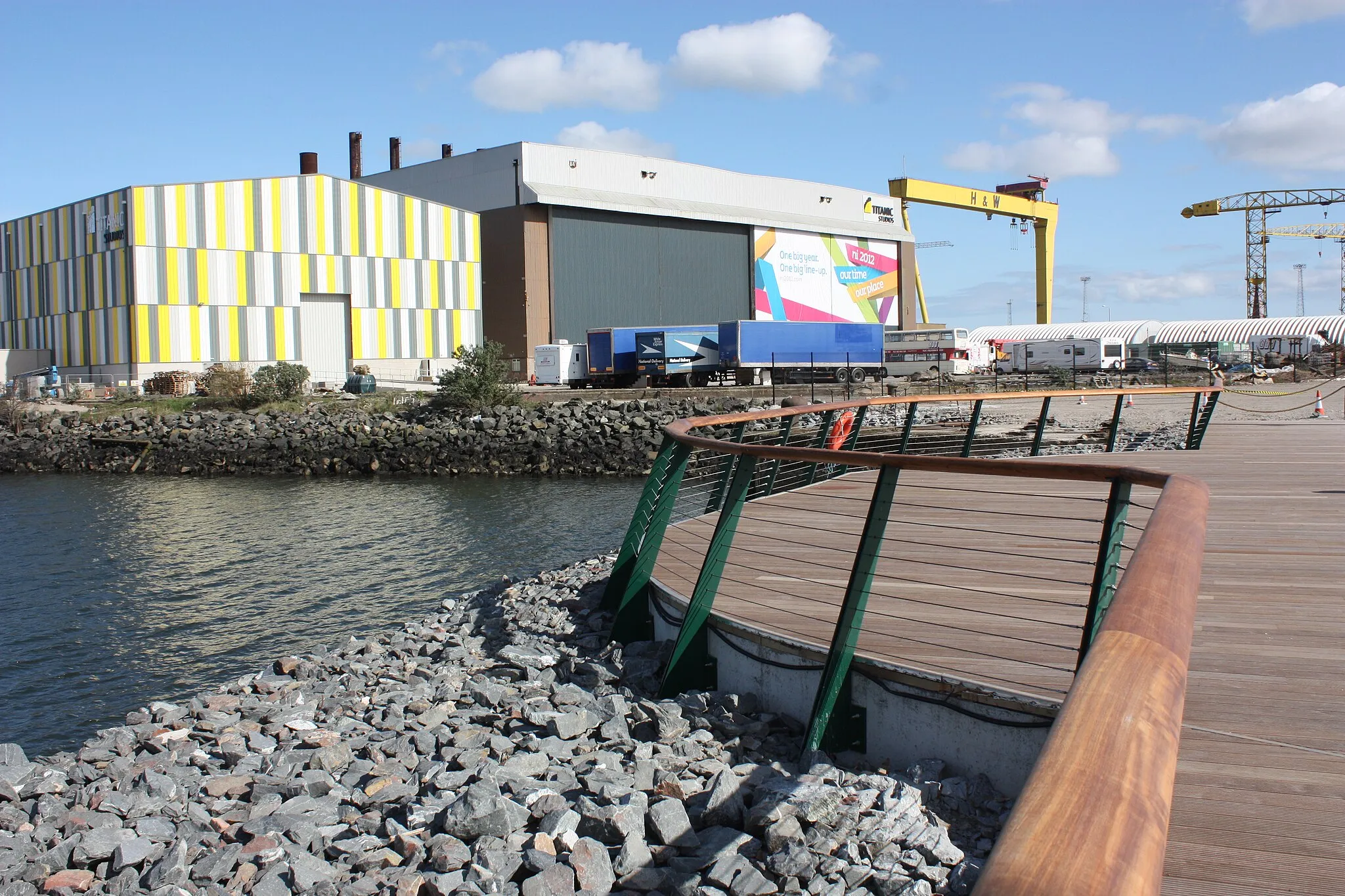 Photo showing: Titanic (formerly Paintshop) Studios and cranes viewed from the end of the Olympic Slipway, Opening Day at Titanic Belfast, Titanic Quarter, Queen's Road, Belfast, Northern Ireland, 31 March 2012