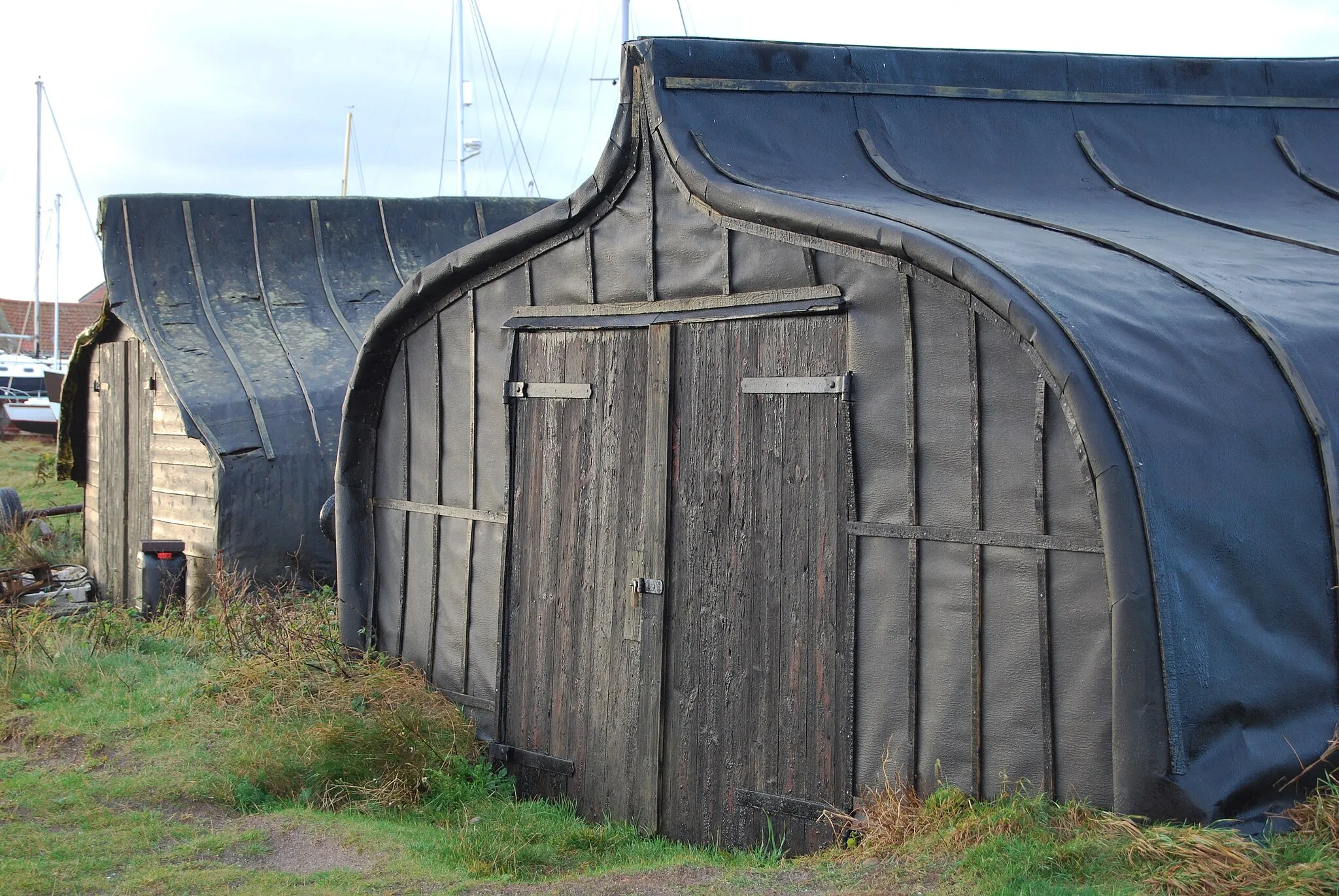 Photo showing: Upturned boats in Lindisfarne harbour in use as sheds