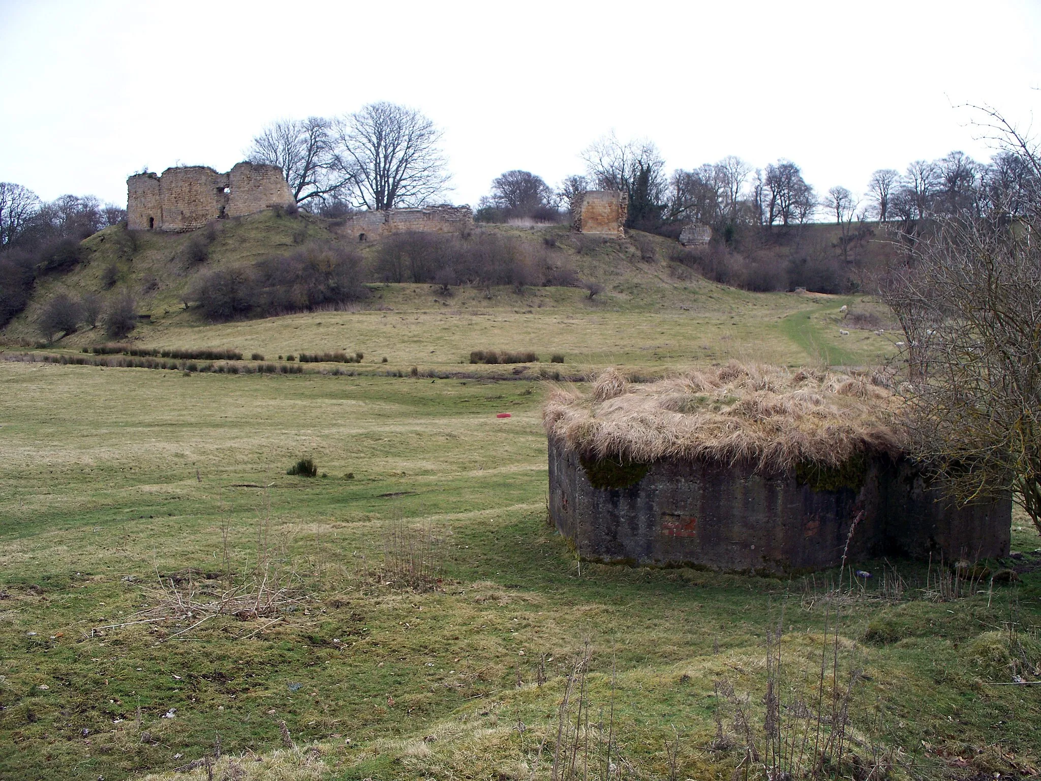Photo showing: A WWII Pillbox in the foreground, Mitford Castle in the background