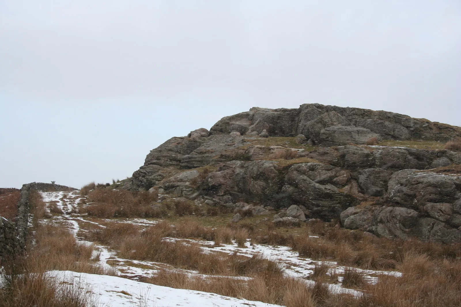 Photo showing: Rock outcrop above St Cuthbert's Cave Ladder stile over wall in background.