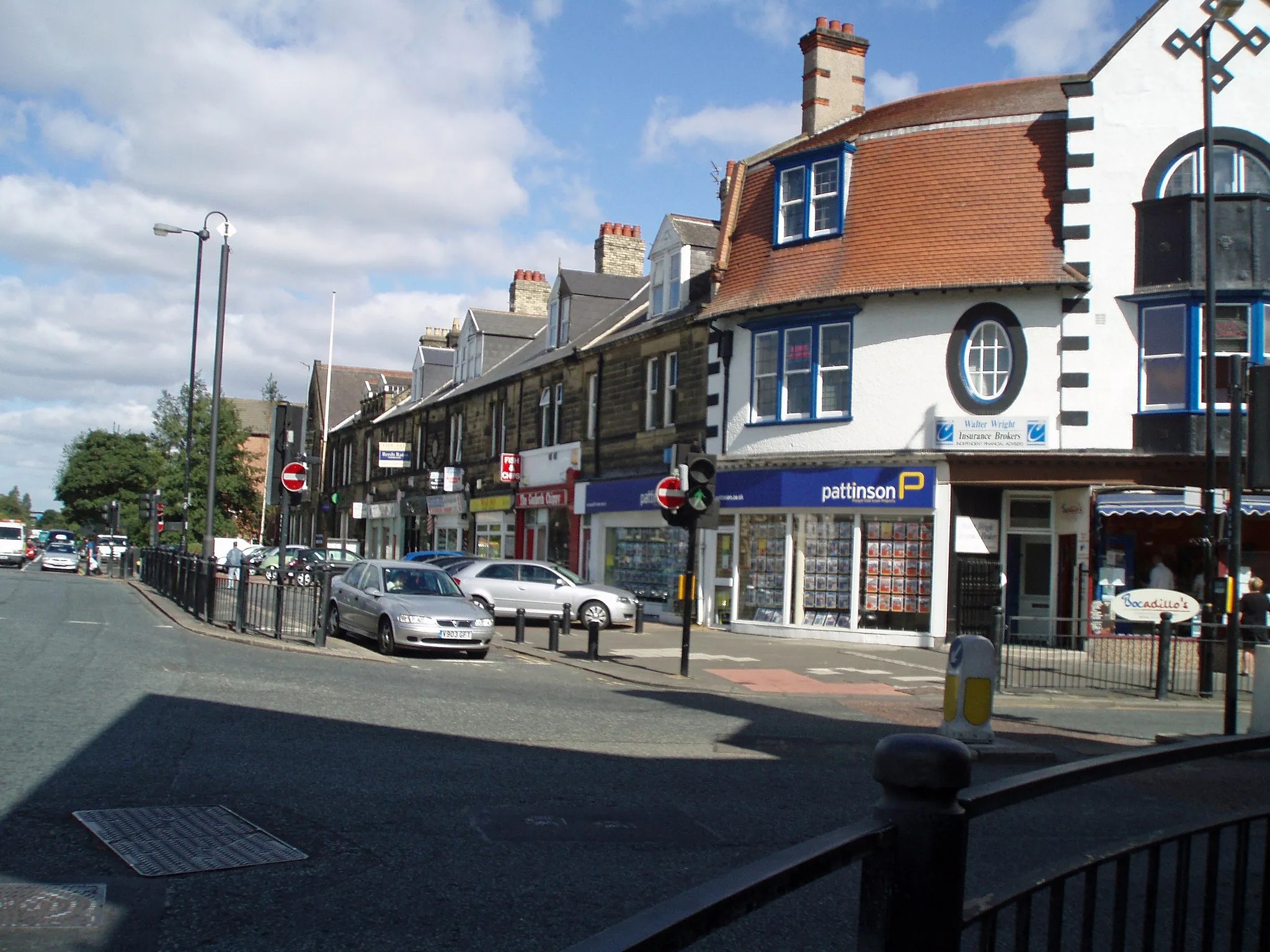 Photo showing: This is a view of Gosforth High Street, Newcastle upon Tyne, England. The image shows the old fire station and the shops that occupy the building.