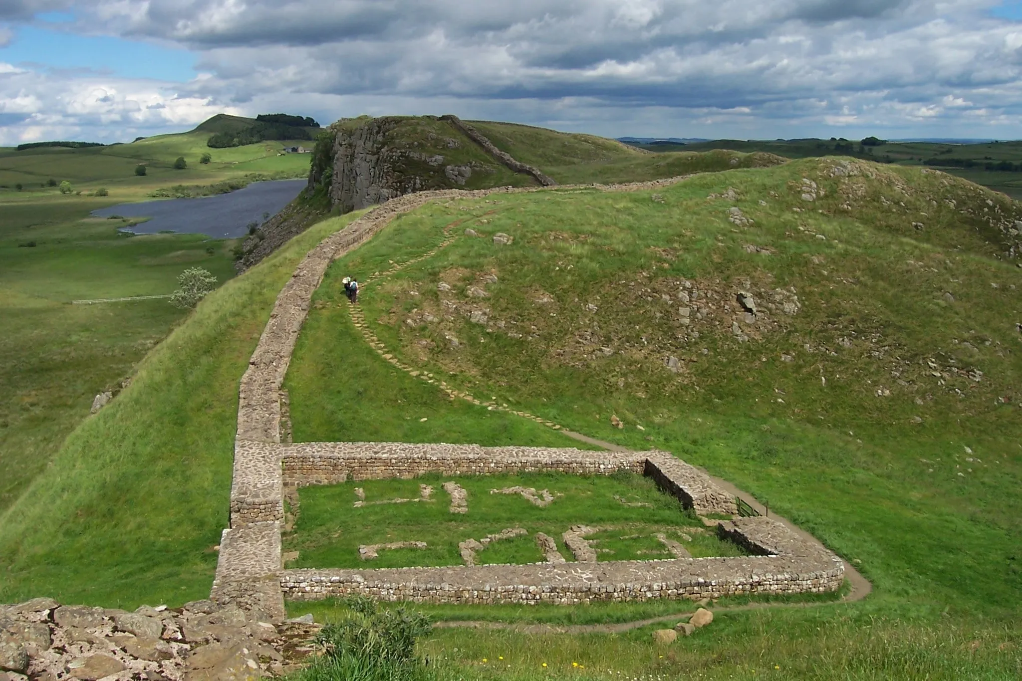 Photo showing: The remains of Milecastle 39 (coordinates 55° 0' 13.12" N, 2° 22' 32.74" W) on Hadrian's Wall; near Steel Rigg, looking east from a ridge along the Hadrian's Wall Path. Milecastle 39 is also known as Castle Nick.
