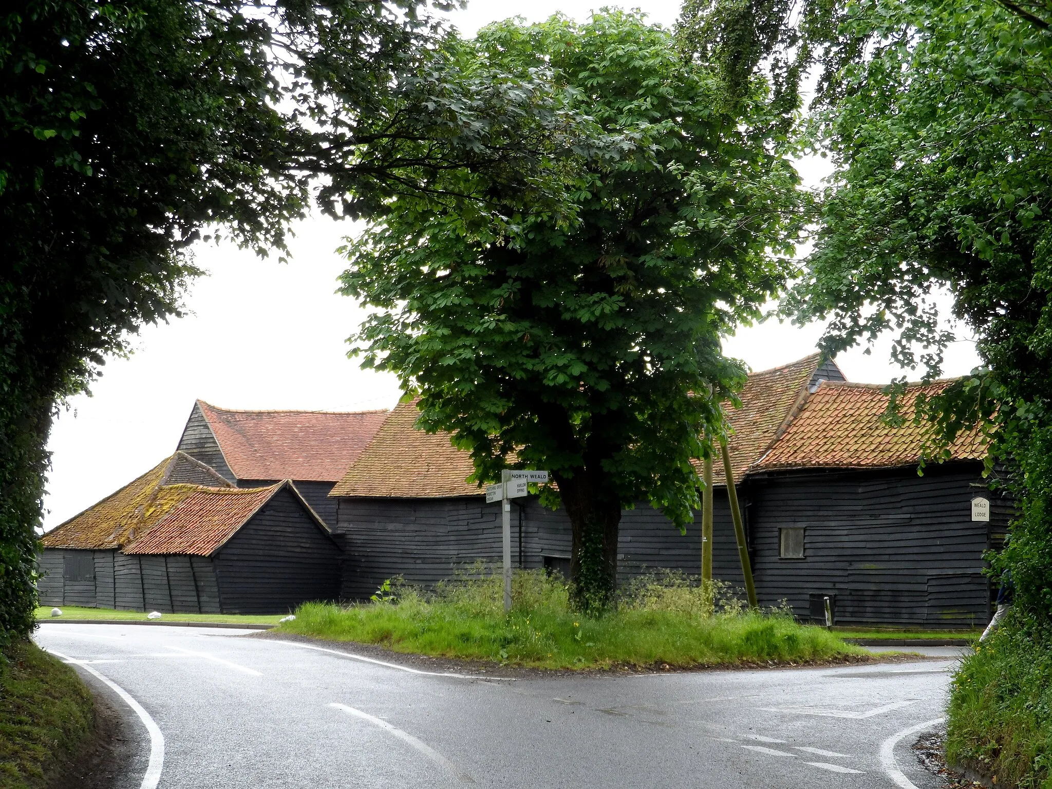 Photo showing: Barns at a junction of country lanes