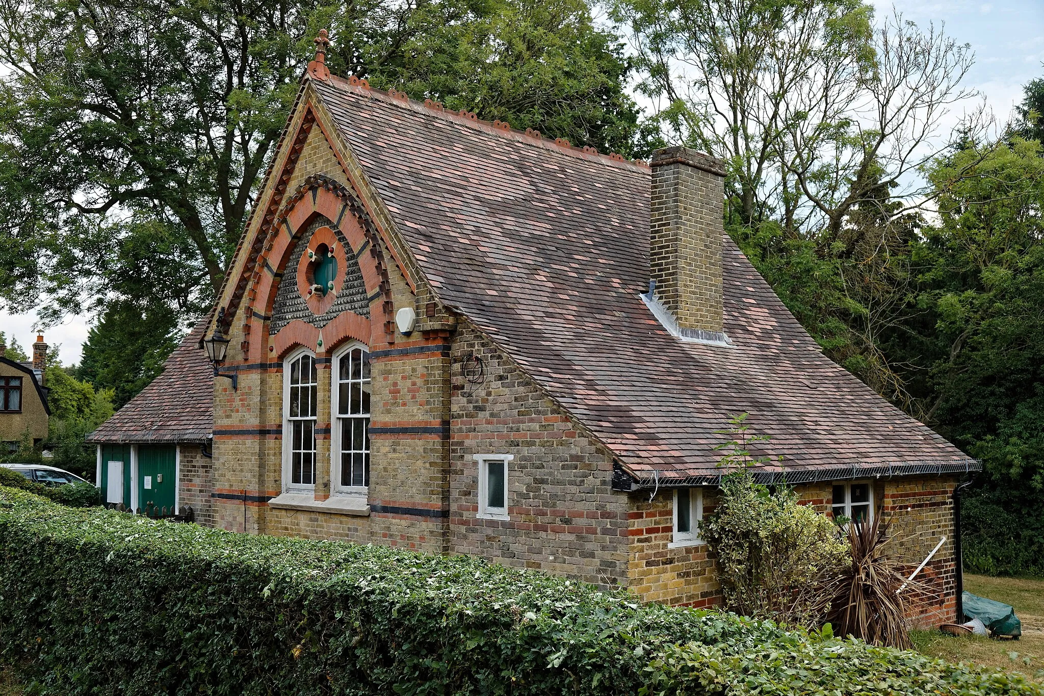 Photo showing: The Grade II listed 1882 parish rooms church hall originally built to accommodate a Sunday School for the Church of St Alban the Martyr, at the point where Coopersale Common Road becomes Houblons Hill in Coopersale, in the civil parish of Epping, Essex, England. Camera: Canon EOS 6D Mark II with Canon EF 24-105mm F4L IS USM lens. Software: File lens-corrected, optimized, perhaps cropped, with DxO PhotoLab, and likely further optimized with Adobe Photoshop CS2.