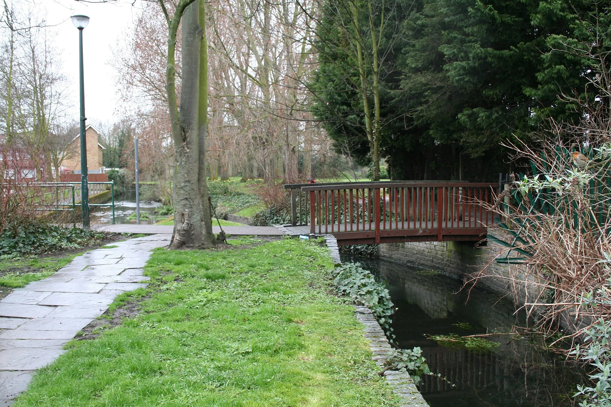 Photo showing: Beddington:  Footbridge over Wandle Mill Stream Looking west. This bridge is only two or three yards north of the footbridge over the main river, which can just be seen at the left, or at 1779457.