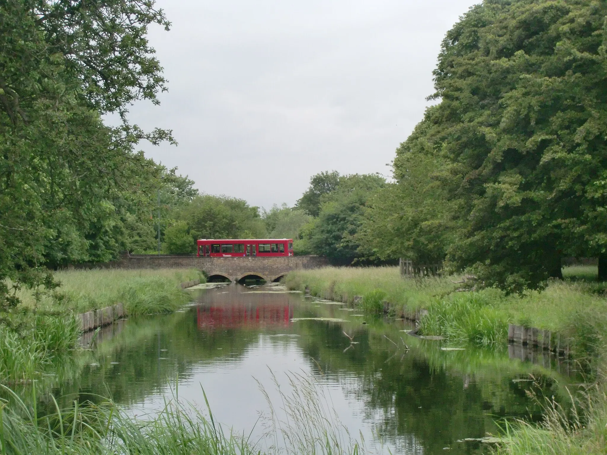 Photo showing: Bus crossing the pantile bridge and reflected in the Longford river