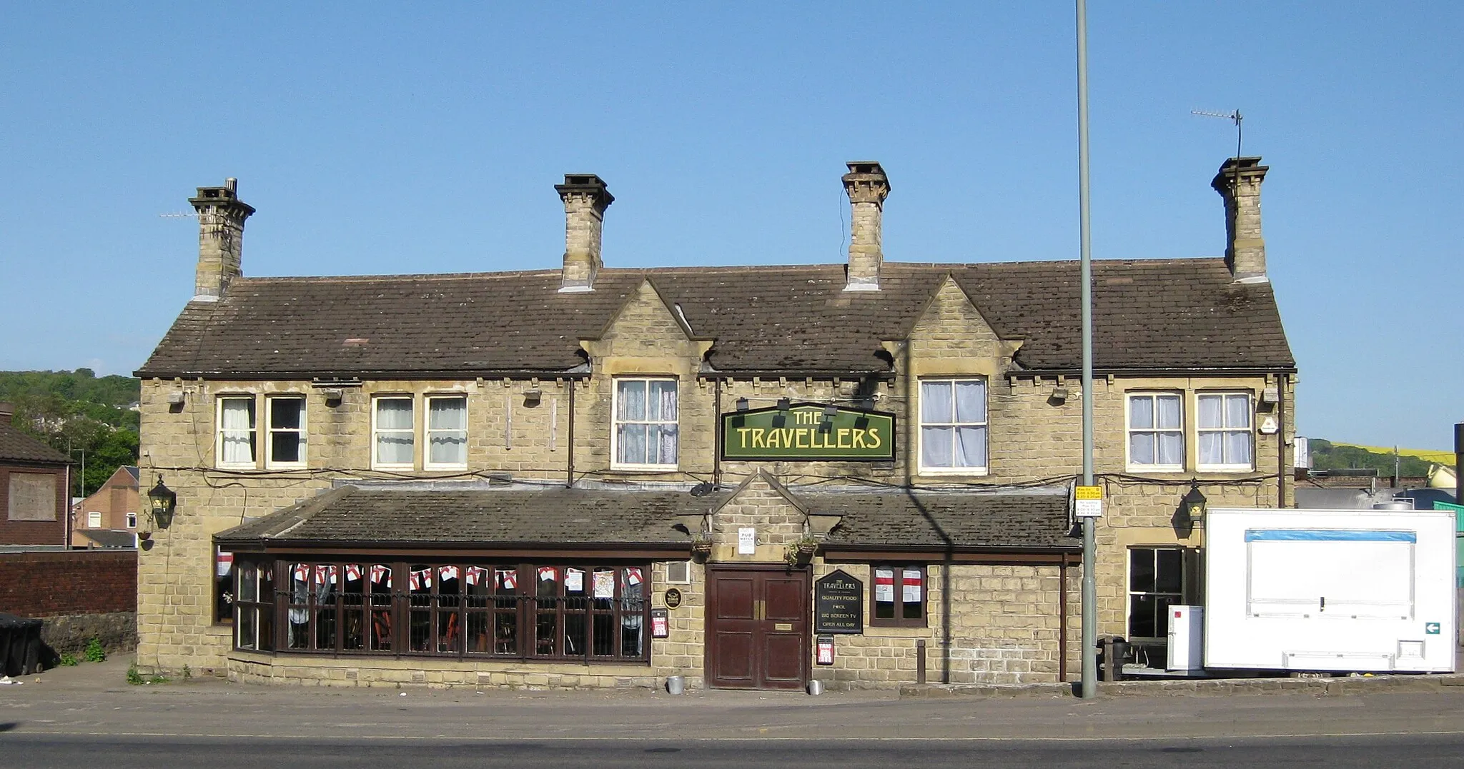 Photo showing: The Travellers.  Public House on Penistone Road, Wadsley Bridge, Sheffield.  Since demolished to construct Sainsbury's. A portable food outlet is sited on the right to provide for fans walking down to Hillsborough stadium later in the day.