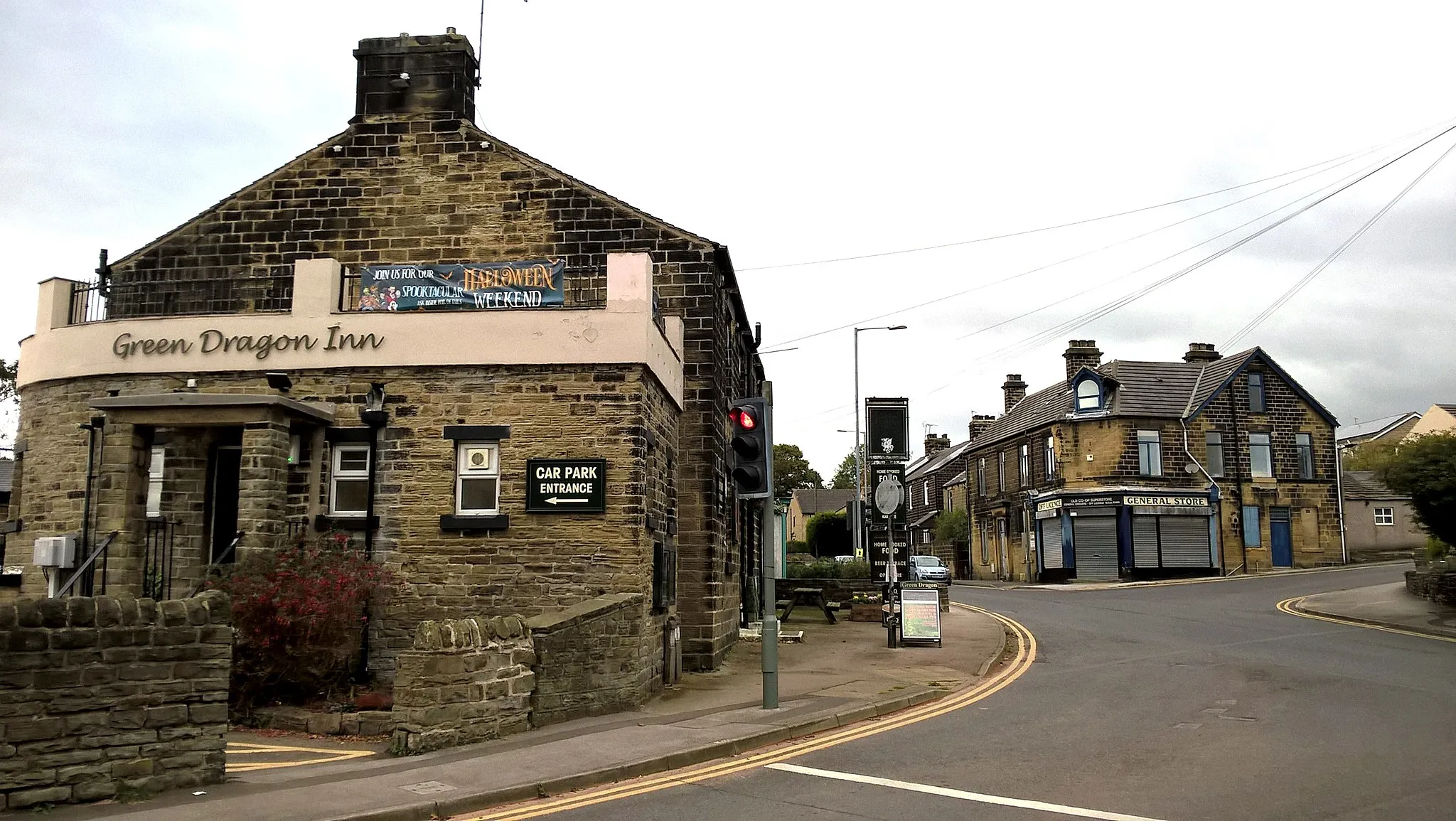 Photo showing: Crossroads in Thurgoland with the Green Dragon public house, the General Store.  Looking NW down the Halifax Road A629, with Cote Lane to left and Smithy Hill on the right.