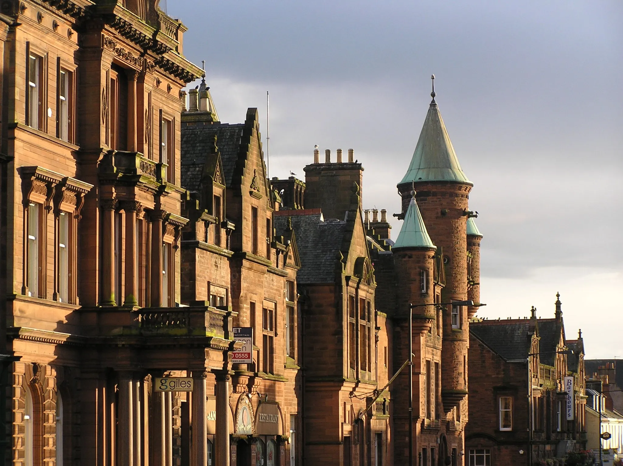 Photo showing: Red sandstone buildings, including the Sheriff Court, shops and offices, in Buccleuch Street, Dumfries, Scotland. Photographed early evening.