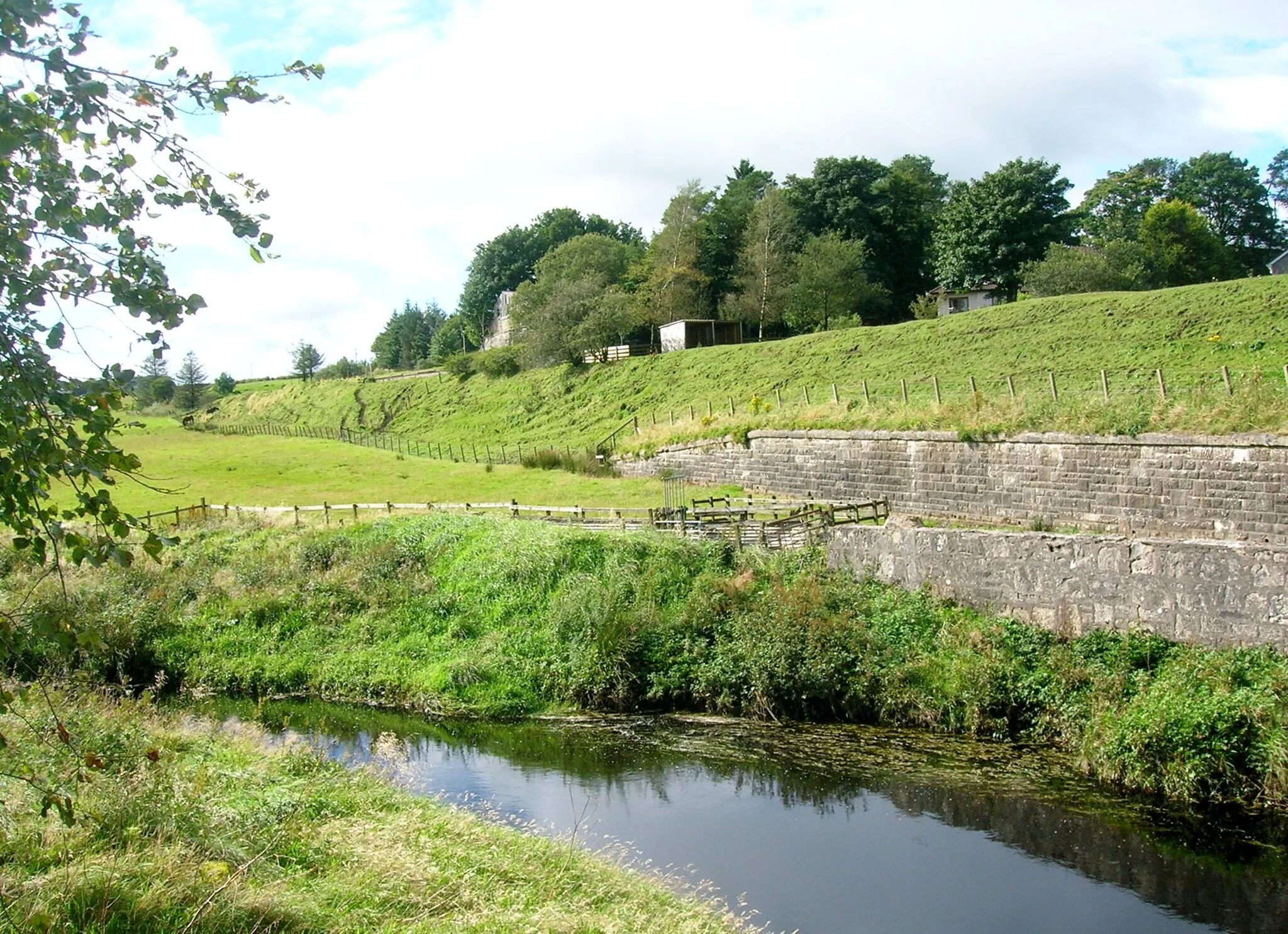 Photo showing: Embankment retaining wall and old Drumclog station site, South Lanarkshire, Scotland.