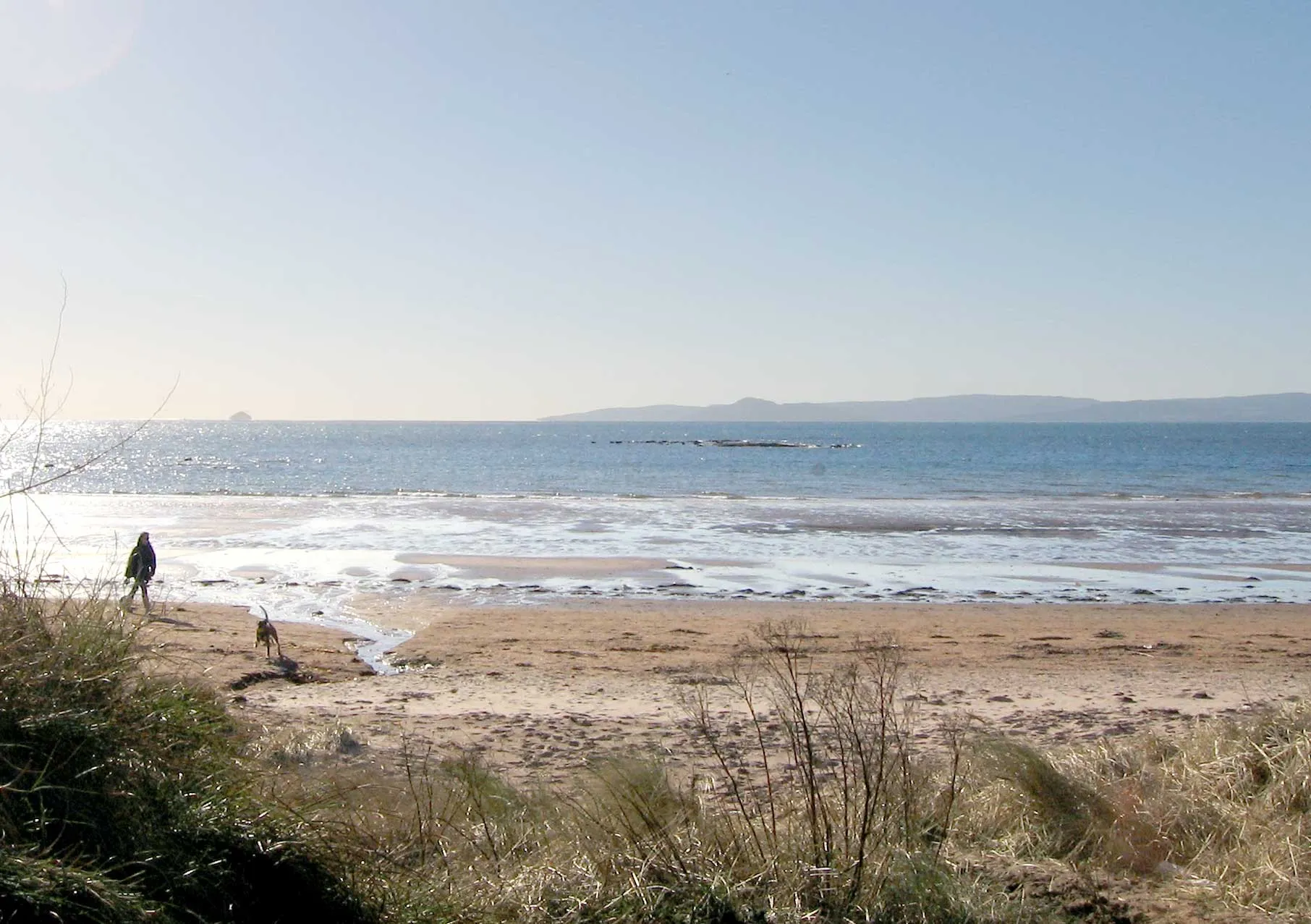 Photo showing: View from the sand beach at Seamill, looking south over the lower Firth of Clyde. The Isle of Arran is visible in the distance to the right, and the small islet of Aisla Craig can just be seen on the horizon. Seamill, Ayrshire, lies close to West Kilbride. 
photograph taken in February 2006 by User:Dave souza.

Any re-use to contain this licence notice and to attribute the work to User:Dave souza at Wikipedia.