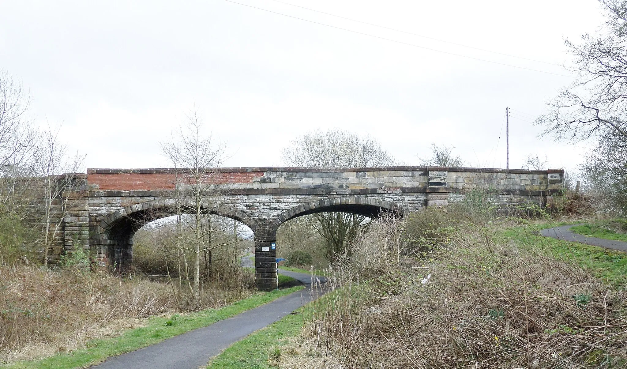 Photo showing: Crosshouse Station overbridge from the station site. East Ayrshire, Scotland. Now part of the Sustrans Cycle rout.