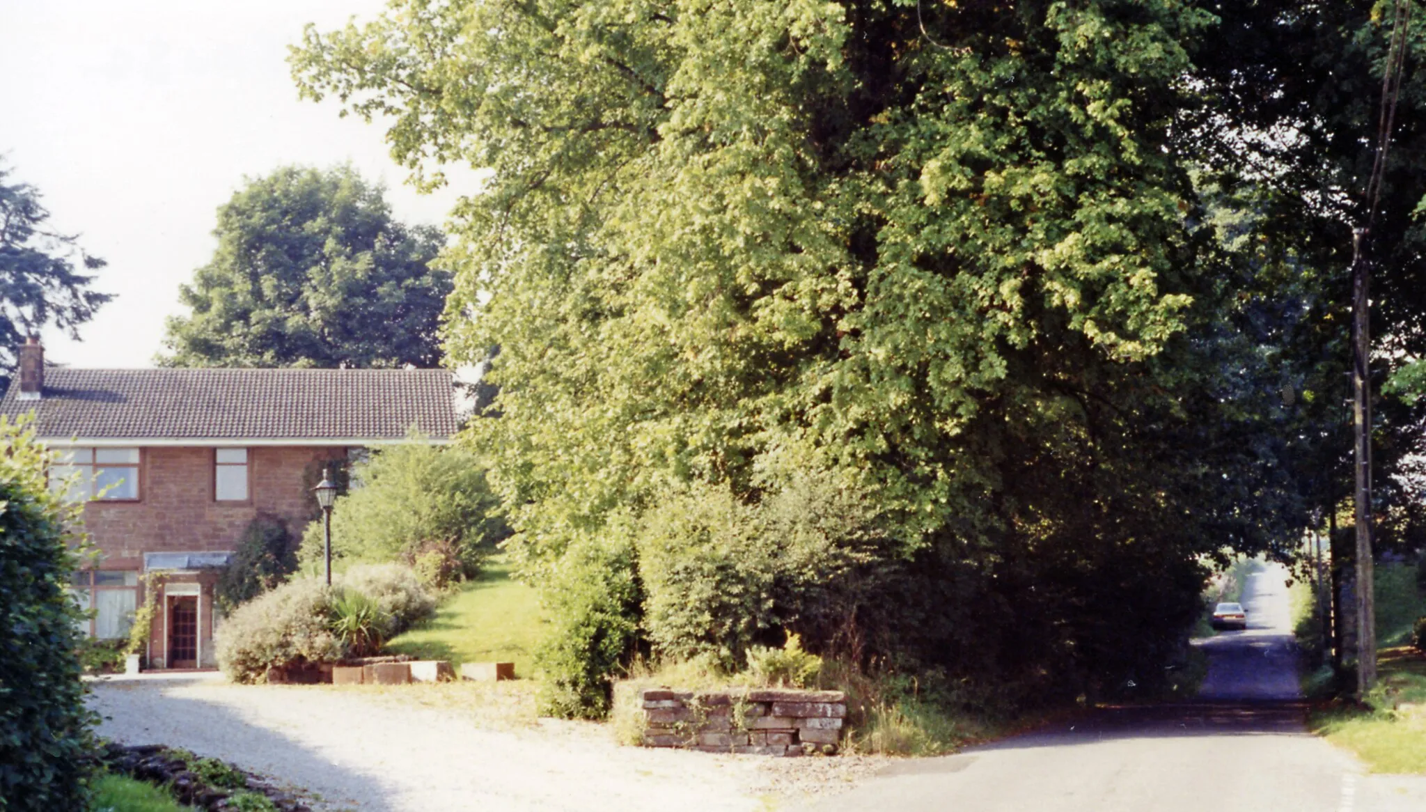 Photo showing: Site of Amisfield station, 1991.
View SE, where the ex-Caledonian line used to cross, from Lockerbie (left) to Dumfries (right). The station had been closed from 19/5/52 and the line from 18/4/66, so little wonder it had been built over.