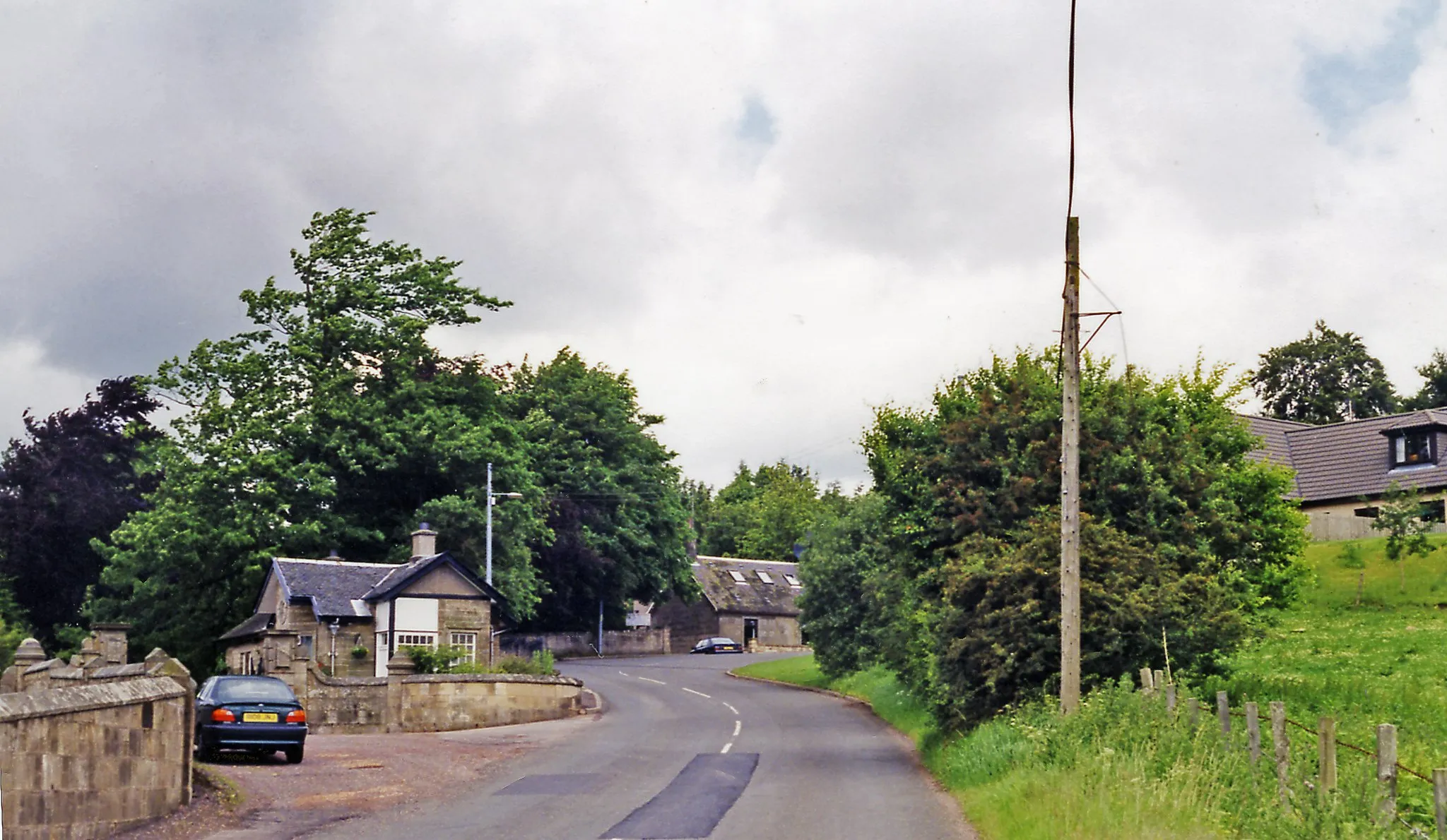 Photo showing: Site of Auchenheath station, 1998.
View NW on the A744 where the ex-Caledonian (Glasgow) - Hamilton (to left) - Brocketsbrae (to right) - Coalburn line had crossed. The station was on the left and closed with the line from Hamilton to passengers from 1/10/51, to goods from 21/9/53. [Precise location of station here is uncertain].