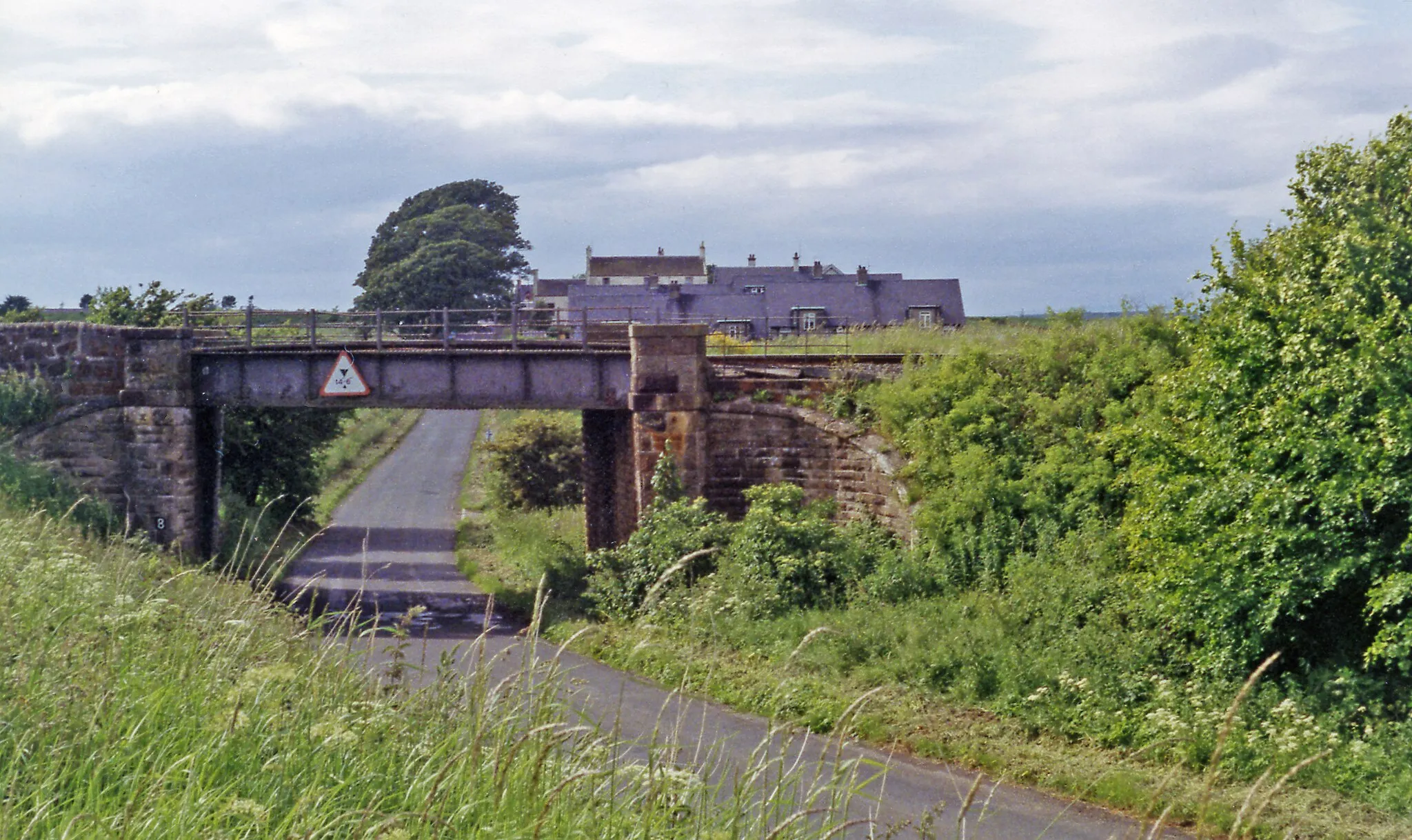 Photo showing: Site of Auchincruive station, 1994.
View SE from the A758, to the bridge where the ex-GSWR Ayr (to left) - Annbank (to right) - Drongan - Muirkirk line crosses. The station, which was up on the left, had been closed to passengers on 10/9/51 when the service (via Drongan) ceased, but the line was still open - for open-cast coal.