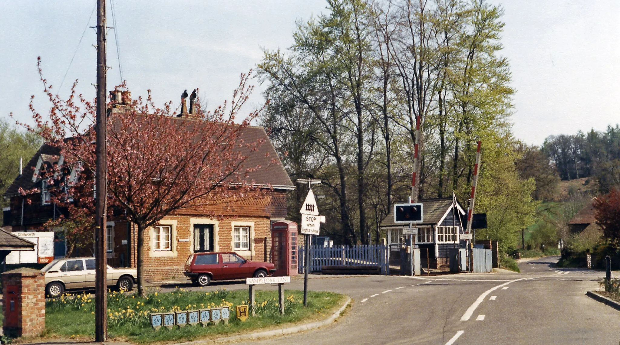 Photo showing: Chilworth & Albury station and crossing, 1984.
View southward over the crossing off the A248: ex-SE&CR Redhill (to left) - Guildford (to right) - Reading line, the station being on the left.