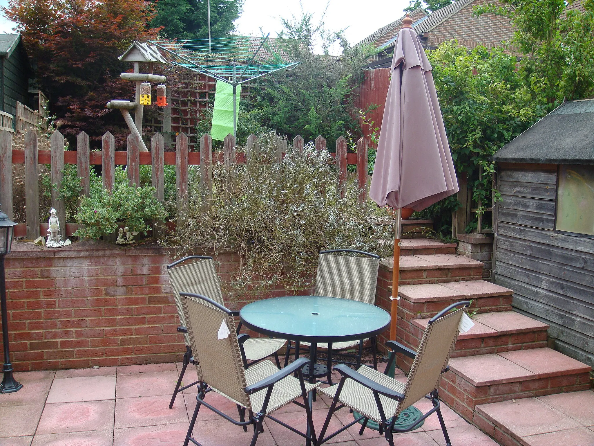 Photo showing: A picture of a back garden, with chairs and a table.