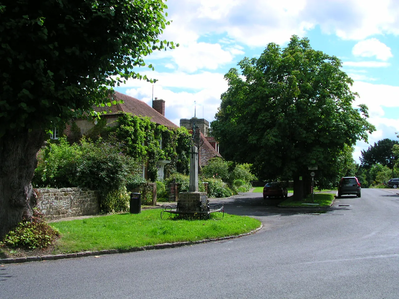 Photo showing: The village centre looking towards St John the Baptist's anglican parish church at Kirdford, West Sussex, England.