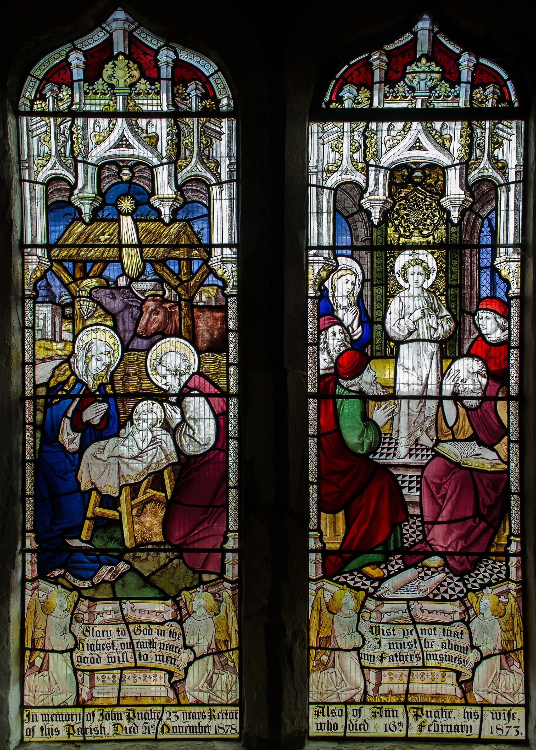 Photo showing: A nativity scene, and Christ amongst the Doctors (And it came to pass, that after three days they found him in the temple, sitting in the midst of the doctors, both hearing them, and asking them questions).
Glass by Burlison & Grylls, 1878.

In memory of John Pughe, Rector, died 1878 and also Ann his wife Died 1873.