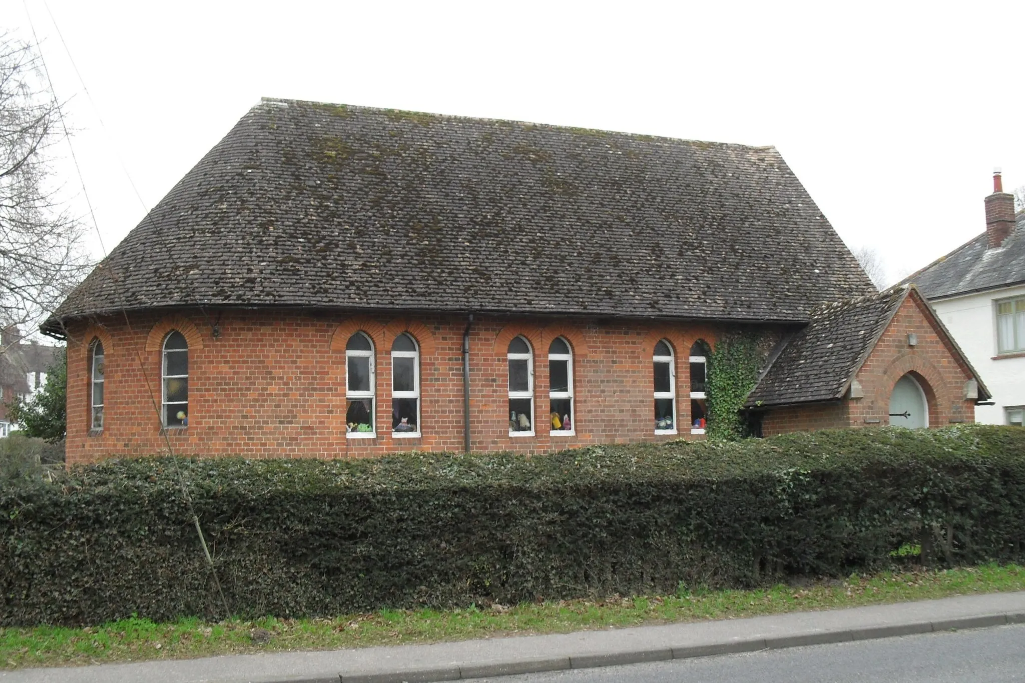 Photo showing: Church of England mission church, Cootham, West Sussex, England. Built as a chapel of ease to Storrington parish church in 1875; now the village hall.