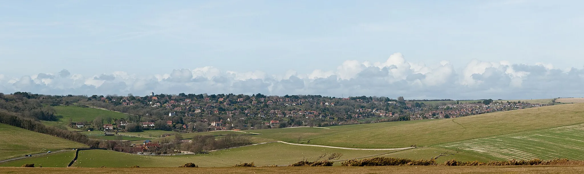 Photo showing: The villages of East Dean (lower valley) and Friston (upper valley) as viewed from along the South Downs Way near Birling Gap in East Sussex, England.