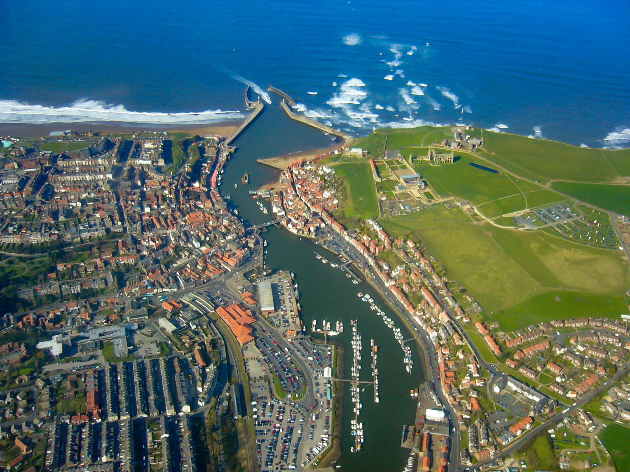 Photo showing: Aerial photo of Whitby in North Yorkshire on the northeast coast of England.  The River Esk flows eastward into the North Sea.