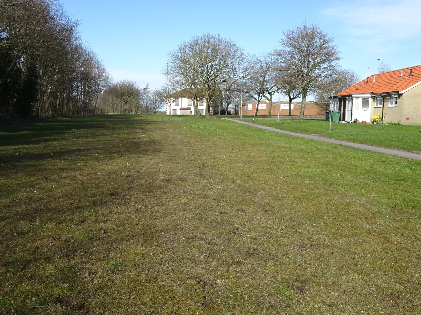 Photo showing: South Hetton railway station (site), County Durham Opened sometime between 1837 and 1858 (early railway records can be murky!) on what became the North Eastern Railway's line from Sunderland to Stockton via Murton, this station closed in 1952.
View north along the track-bed towards Murton and Sunderland from somewhere near the ends of the platforms. The station was however in a cutting below the camera position, which has since been filled in and landscaped. The former Railway Hotel in the distance was standing but derelict when this image was taken.