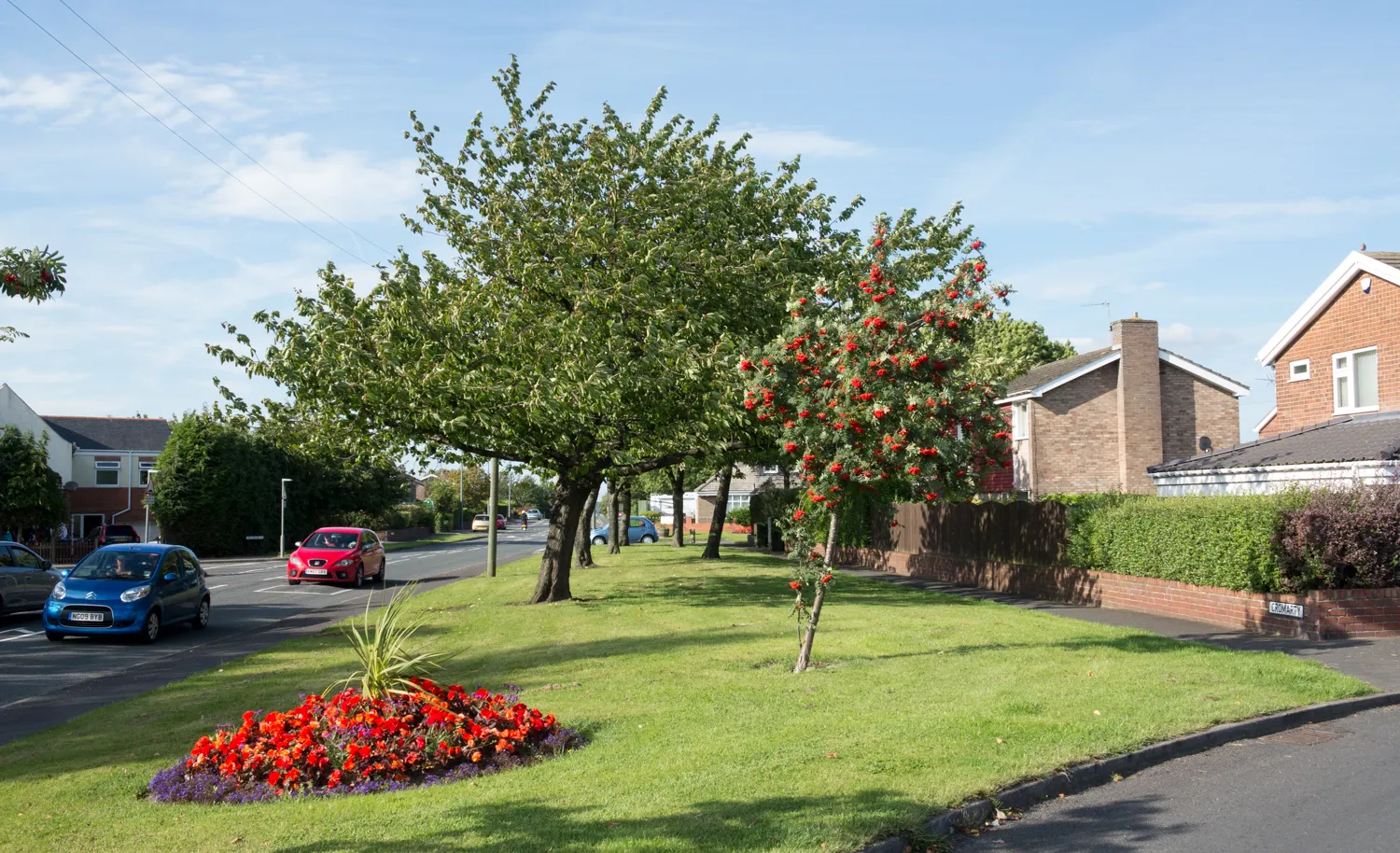 Photo showing: Grassed strip with flower bed and trees in Ouston, County Durham