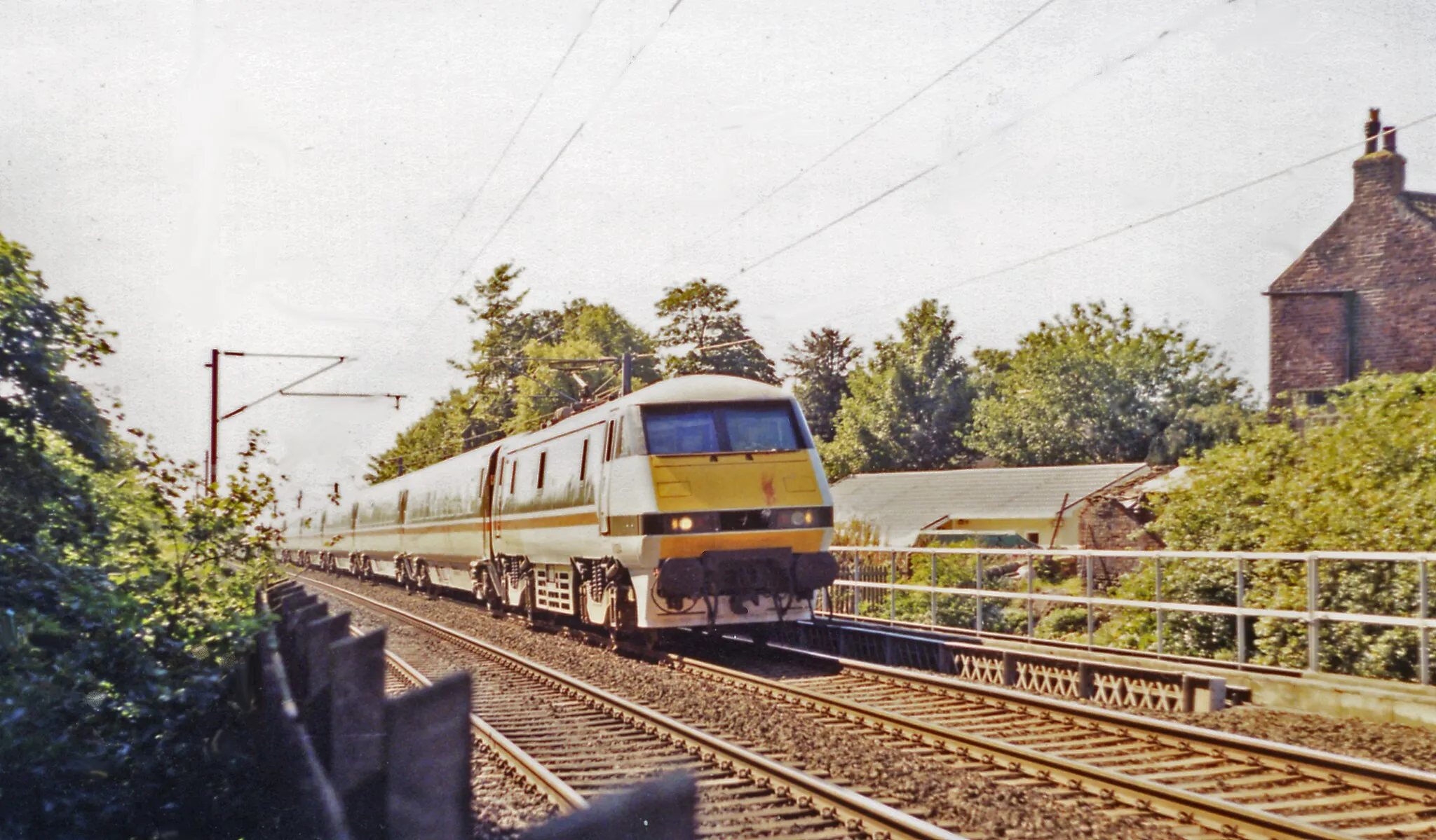 Photo showing: Down IC225 express on the ECML passing site of Aycliffe station, 1991.
View southward, towards Darlington, York and the South: ex-NER section of the recently electrified East Coast Main Line. There was trace of the station, which had been closed nearly 40 years before, on 2/3/53.