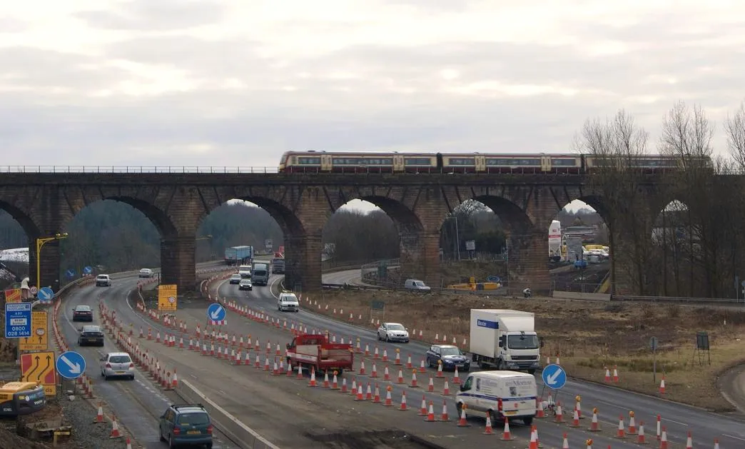 Photo showing: Castlecary Viaduct The A80 upgrade continues as a Glasgow-Edinburgh train crosses the viaduct.