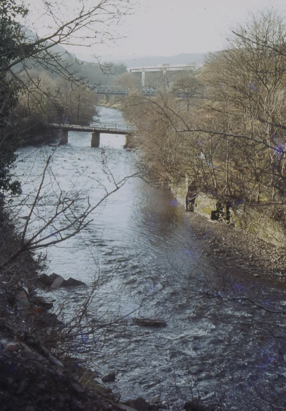 Photo showing: Quakers Yard. View up Taff to A470 bridge. February 1985