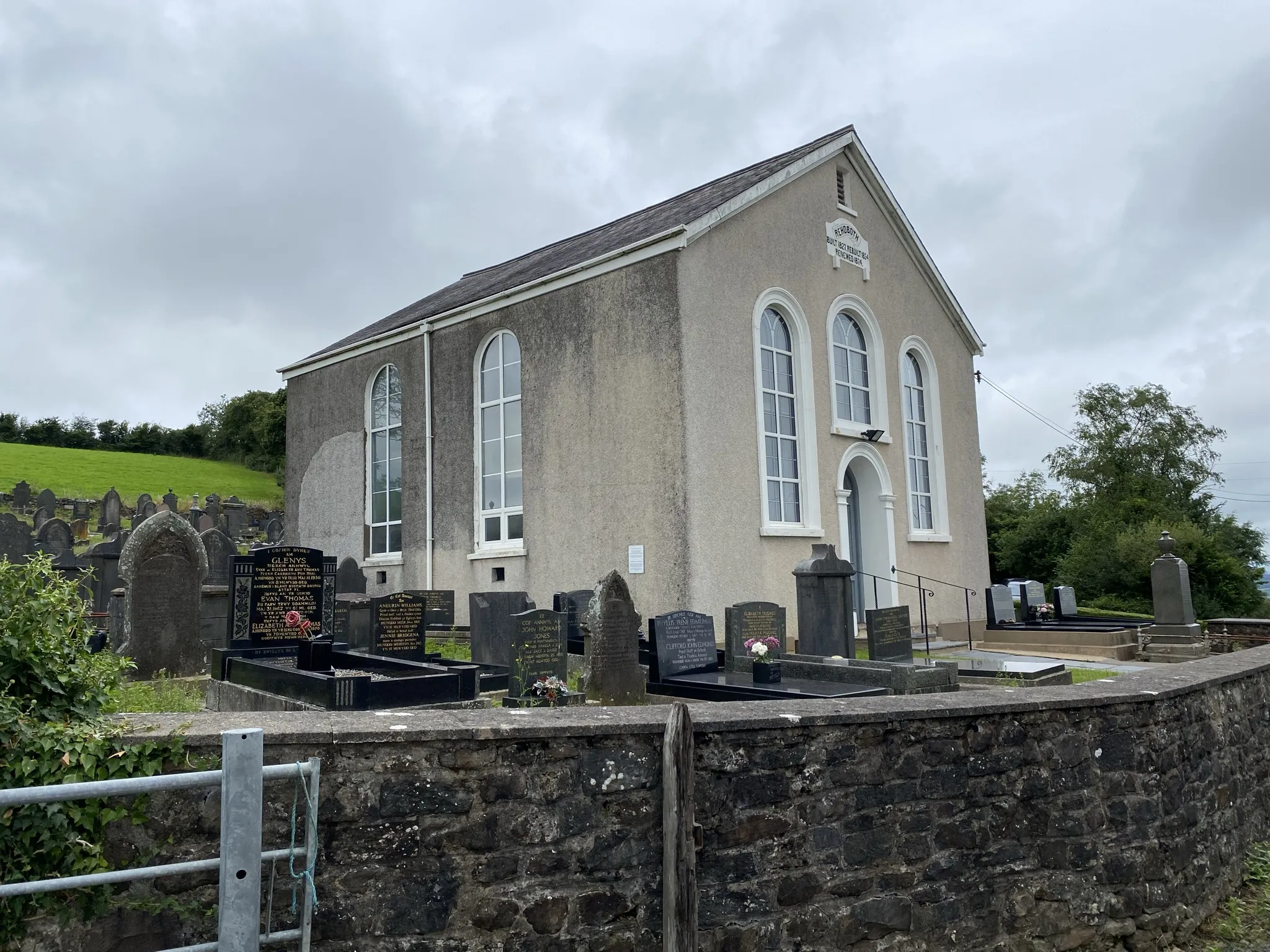 Photo showing: Rehoboth Chapel.
Remote rural chapel near Pen y Mynydd.

Situated about half way between Pen-y-Mynydd and Five Roads on the road which runs between the two villages. According to Coflein (https://coflein.gov.uk/en/site/6617/} the chapel was built in 1819, rebuilt in 1827 and 1855, and further modified in 1875.
