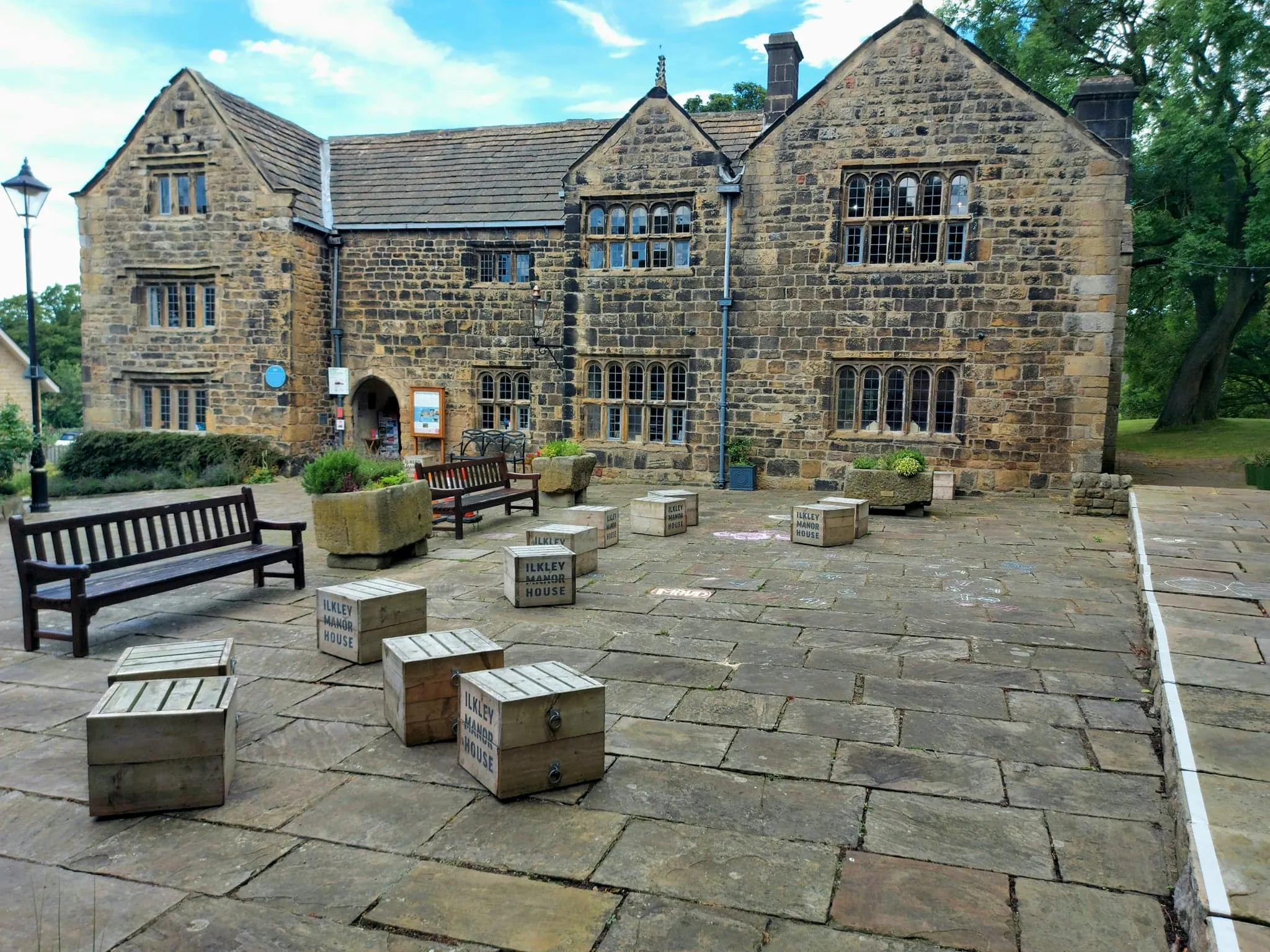 Photo showing: The front or south-facing side of Ilkley Manor House; a tripartite Medieval building in Ilkley, West Yorkshire. You can also see the courtyard where there are boxes stencilled with the Manor House logo.