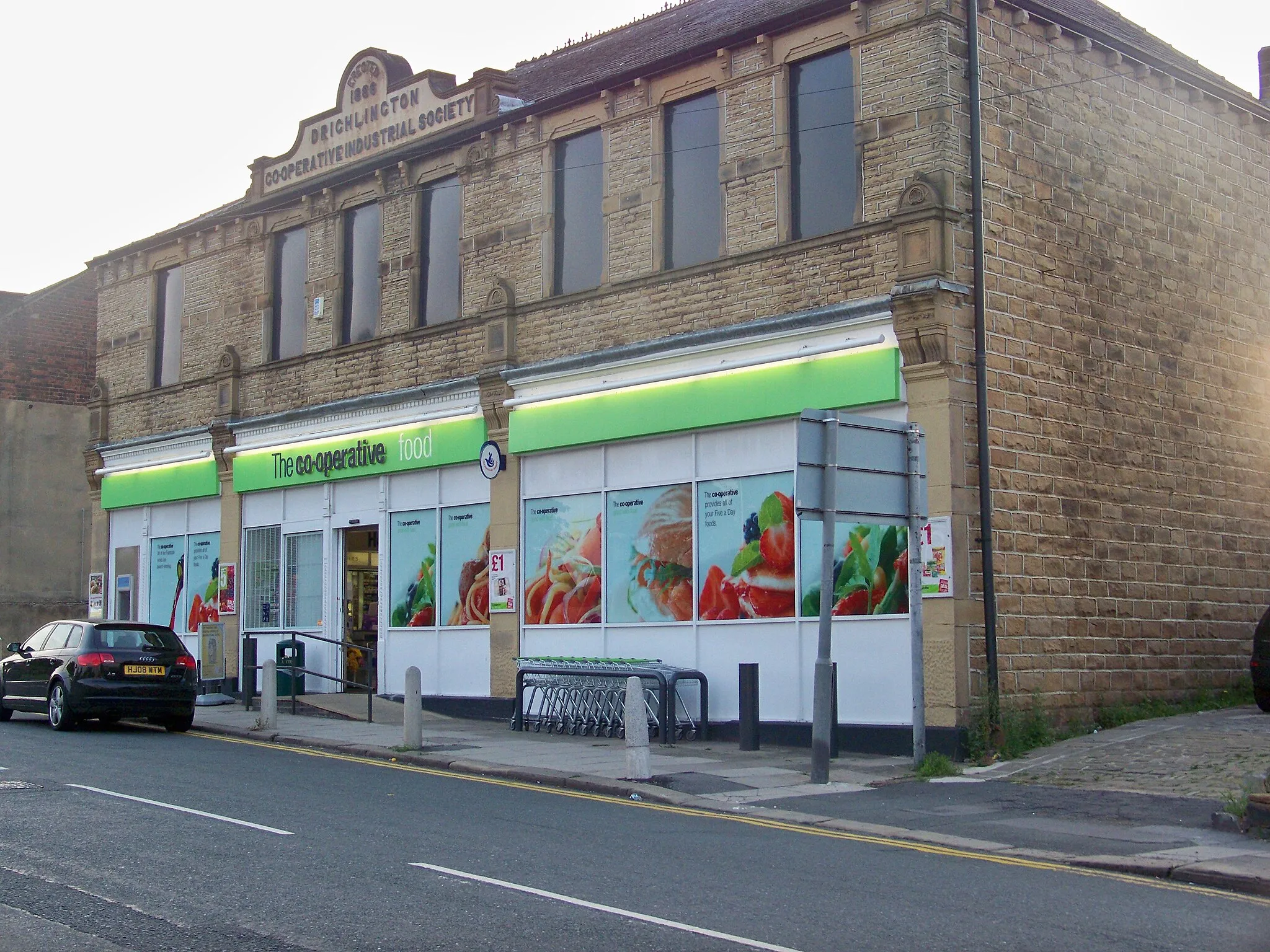 Photo showing: The Co-operative in Drighlington, Leeds, West Yorkshire.  Notice the inscription Erected 1886 - Drighlington Co-operative Industrial Society on the gable.  Taken on the evening of Wednesday 1st July 2009.