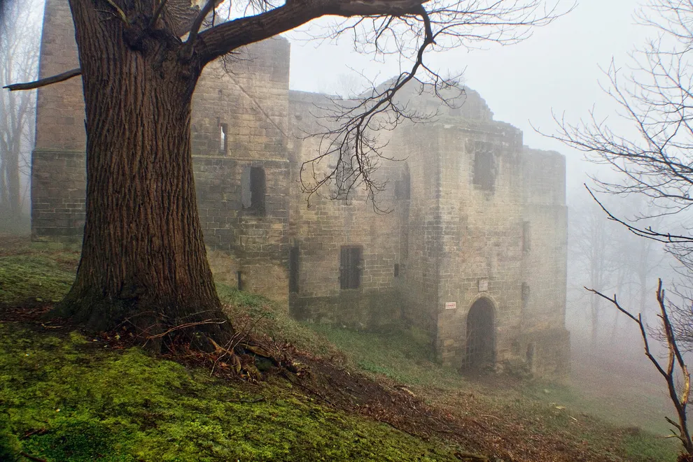 Photo showing: Shrouded in a thick blanket of fog at the break of dawn, this is Harewood Castle: an ancient medieval fort which was built in the 14th century. You can view the original high-resolution photograph, along with other views of the castle, online in this set of images.
